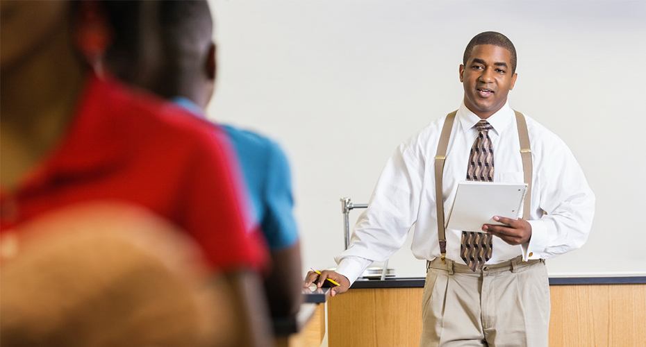 african american teacher lecturing to class full of students