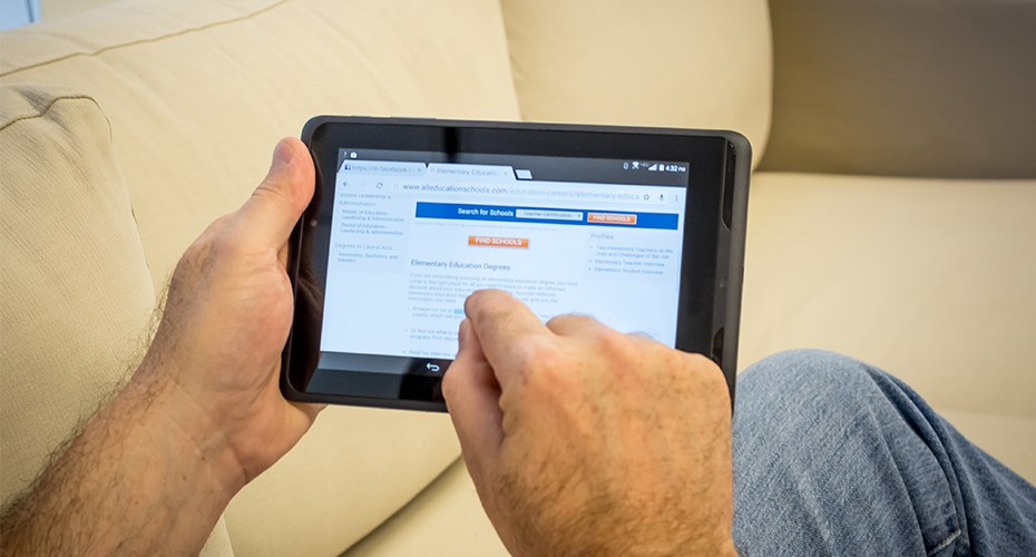 older student using tablet to take online degree program