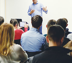 teacher leads classroom of adult learners