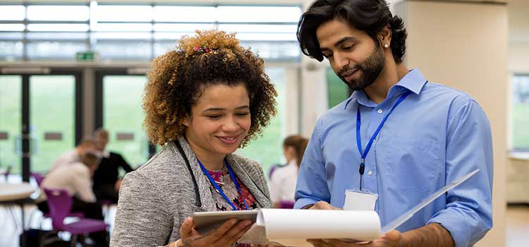 two teachers review student roster