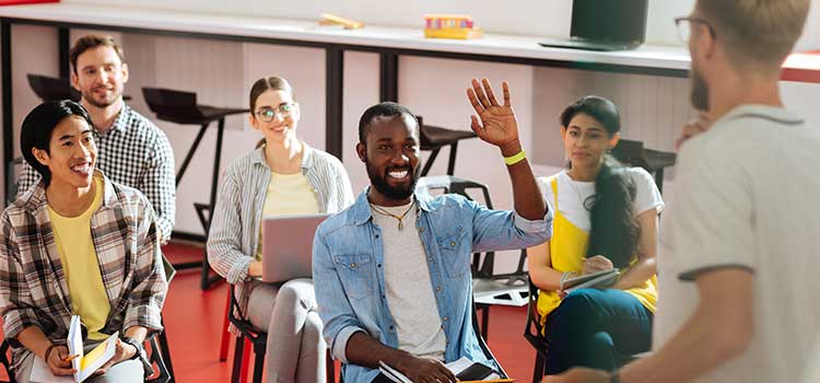 man raising hand in esl class