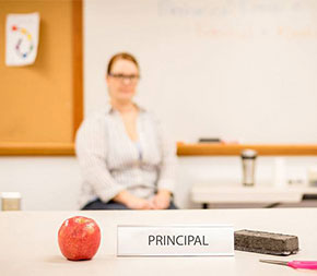 female principal sitting in her office