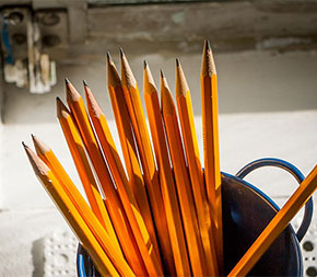 cupful of pencils signifying class supplies for elementary degree student