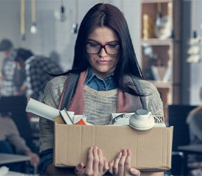 teacher carrying box of belongings after teacher layoffs