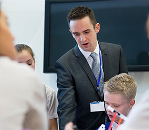 science teacher works one on one with class of students