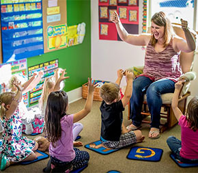 teacher having play time with pre school students