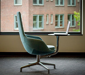 chair and laptop with view signifying a perk of earning a degree online