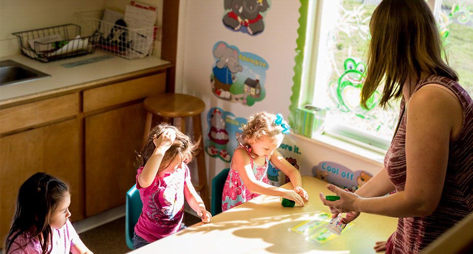 preschool teacher with young students