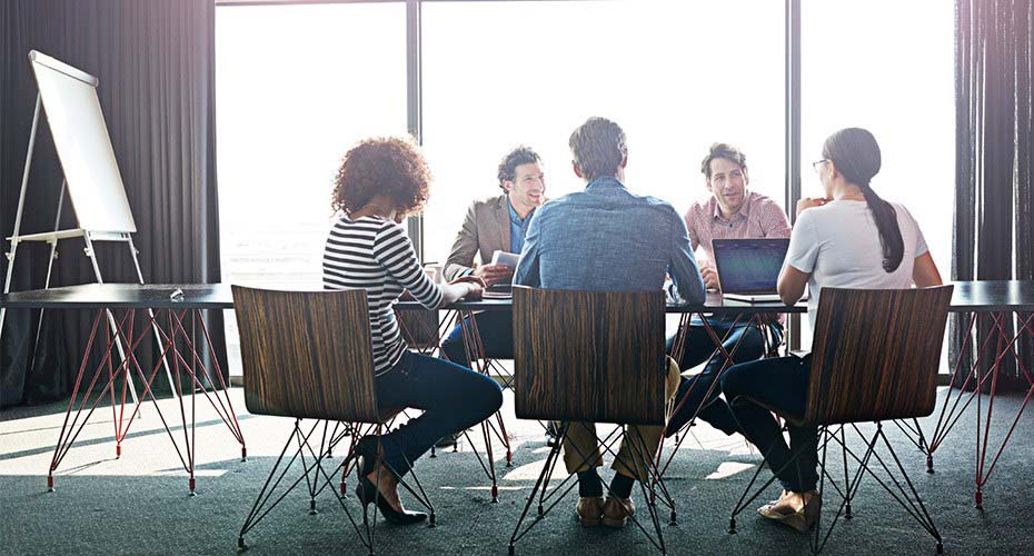 team of business people meeting together in boardroom