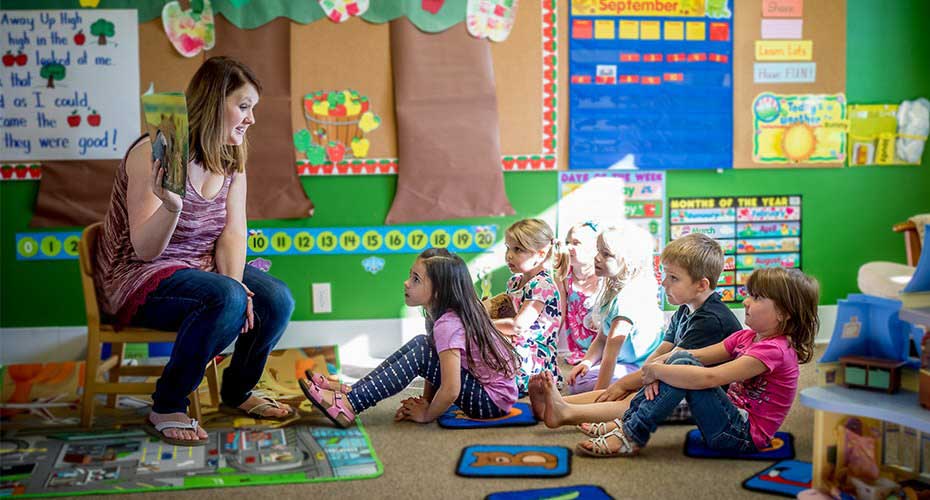 reading teacher at storytelling time with young students