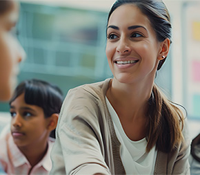 esl teacher sites in classroom with young students