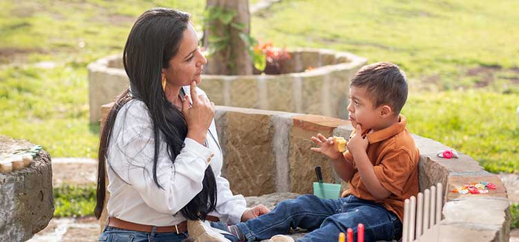 special education teacher teaches boy sign language